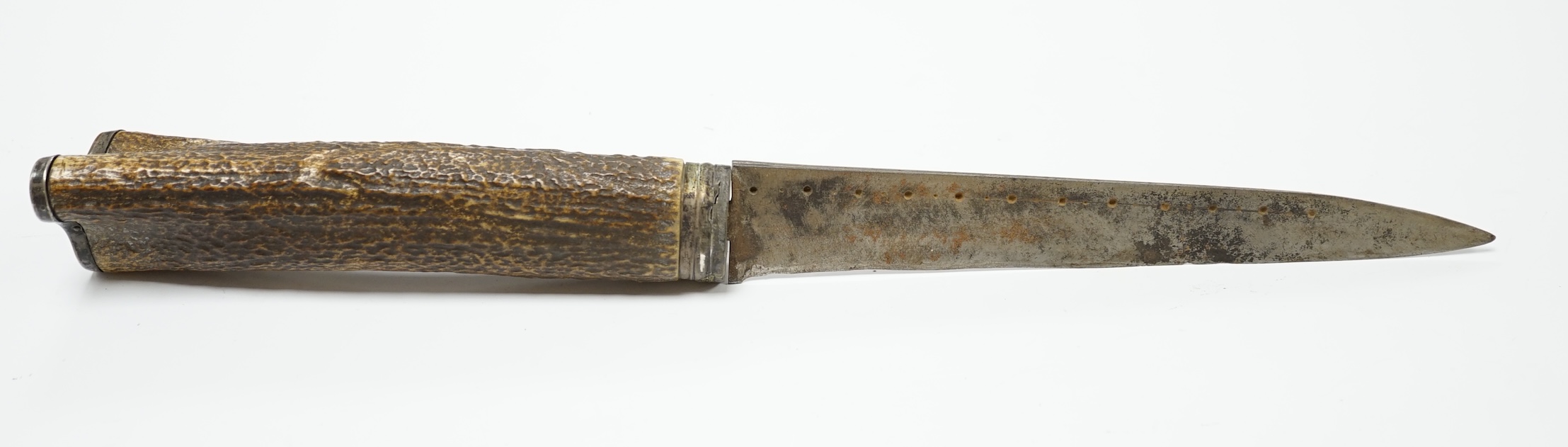 A Scottish dagger c.1900 with silvered mounts, including old initials engraved to pommel and applied to top mount, with deer skin covered sheath and antler grip, blade 19cm.